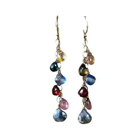 Transformation multigemstone Dancing Amulets earrings. Six gemstone teardrops in colors of yellow citrine, green tourmaline, blue kyanite, red garnet, pink tourmaline, and silver labradorite hang from a gold chain
