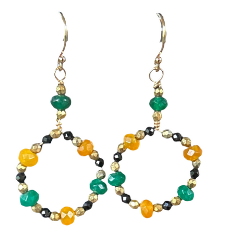 earrings of green and yellow beads form a circle with tiny gold and black stones and hang from a single green roundel with gold accents on gold earrings
