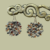 Earrings of light and dark honey colored roundel stones mixed with pyrite roundels knitted in circle shape with gold wire dancing amulets