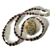 Cat Cave: fossil coral and red tiger eye amulet