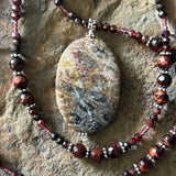 Cat Cave: fossil coral and red tiger eye amulet
